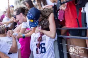 Elkhorn South’s Ellie Sonderman (26) is embracing a loved one after winning a high school state semifinals soccer game against Lincoln Southwest on Friday, May 15 2026 in Omaha, Nebraska. Photo By Jack Stephens.