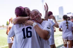 Elkhorn South’s Neve Murphy (16) is embracing her teammates after winning a high school state semifinals soccer game against Lincoln Southwest on Friday, May 15 2026 in Omaha, Nebraska. Photo By Jack Stephens.