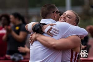 Nebraska Cornhusker Axelina Johansson hugs her coach after getting a personal best in women’s shot put during the Big Ten OTF Championships on May 16, 2026, in Lincoln, Nebraska. Photo by Brandon Tiedemann.