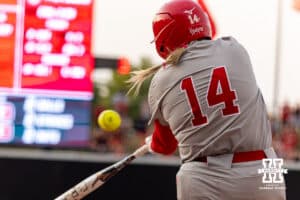Nebraska Cornhusker Kacie Hoffmann (14) hits a two-run double in the sixth inning against the South Dakota Coyotes during the first round of the NCAA Softball Regionals on Friday, May 15, 2026, in Lincoln, Neb. Photo by John S. Peterson.