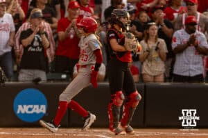 Nebraska Cornhusker Hannah Coor (23) scores a run in the fifth against South Dakota Coyote catcher Abi Brown (7) during the first round of the NCAA Softball Regionals on Friday, May 15, 2026, in Lincoln, Neb. Photo by John S. Peterson.