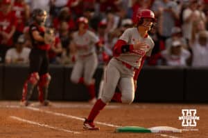 Nebraska Cornhusker starting pitcher/relief pitcher Hannah Camenzind (9) hits a double driving in a run and out at third against the South Dakota Coyotes in the fifth inning during the first round of the NCAA Softball Regionals on Friday, May 15, 2026, in Lincoln, Neb. Photo by John S. Peterson.