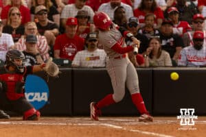 Nebraska Cornhusker starting pitcher/relief pitcher Jordyn Frahm (98) get a hit for a double against the South Dakota Coyotes in the fifth inning during the first round of the NCAA Softball Regionals on Friday, May 15, 2026, in Lincoln, Neb. Photo by John S. Peterson.