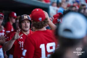 Nebraska Cornhusker Joshua Overbeek (4) celebrates in the dugout during a college baseball game on May 12, 2026, in Omaha, Nebraska. Photo by Brandon Tiedemann.