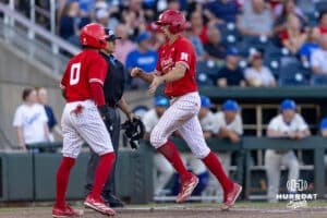 Nebraska Cornhusker infielder Dylan Carey (15) gives Jeter Worthley after both scored runs in the fifth against the Creighton Bluejays during a college baseball game on Tuesday, May 12, 2026, in Omaha, Neb. Photo by John S. Peterson.
