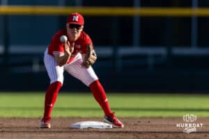 Nebraska Cornhusker infielder Rhett Stokes (9) makes an out at second to turn a double play to fininsh the inning against the Creighton Bluejays during a college baseball game on Tuesday, May 12, 2026, in Omaha, Neb. Photo by John S. Peterson.