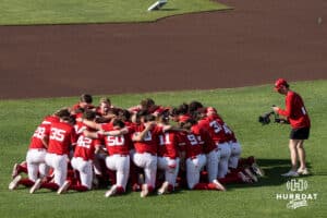 The Nebraska Cornhuskers huddle before a college baseball game on May 12, 2026, in Omaha, Nebraska. Photo by Brandon Tiedemann.