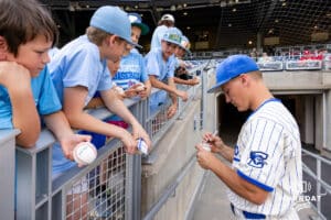 Creighton Bluejay infielder Joe Washburn (1) signs an autograph for some fans before taking on the Nebraska Cornhuskers during a college baseball game on Tuesday, May 12, 2026, in Omaha, Neb. Photo by John S. Peterson.