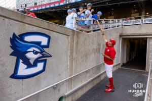 Nebraska Cornhuskers pitching coach Rob Childress signs autographs for some young baseball fans before taking on the Creighton Bluejays during a college baseball game on Tuesday, May 12, 2026, in Omaha, Neb. Photo by John S. Peterson.
