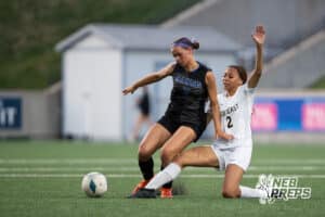 Omaha Marian's Cleo Washington (7) tackled by Lincoln Southeast's Avaerie Graves (2) during the girls' Class A soccer match against Lincoln Southeast on Monday, May 11, 2026, in Omaha, Nebraska. Photo by Jackson D. Luethje.