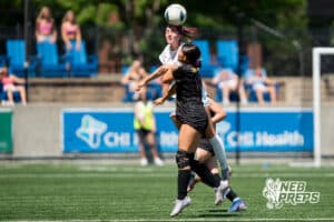 Elkhorn South's Neve Murphy (16) header over Bellevue West's Kiana Sogbadji (13) during the girls Class A quarter-final soccer match on Monday, May 11, 2026, in Omaha, Nebraska. Photo by Jackson D. Luethje.