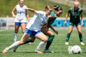 Lincoln Southwest's Bella Hertzel (11) battles for possession with Lincoln East's Ameena Omerović (11) during the girls Class A quarter-final soccer match on Monday, May 11, 2026, in Omaha, Nebraska. Photo by Jackson D. Luethje.