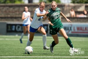 Lincoln Southwest's Kira Schafer (20) defended by Lincoln East's Brynn Hershberger (6) during the girls Class A quarter-final soccer match on Monday, May 11, 2026, in Omaha, Nebraska. Photo by Jackson D. Luethje.