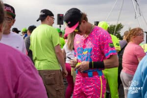 Glow Mojis signing a baseball before a Cosmic Baseball game on Saturday, May 9, 2026, in Omaha, Neb. Photo by Jandi Green.