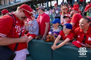 Nebraska Cornhusker infielder Josh Overbeek (4) signs an autograph after the win against the Iowa Hawkeyes during a college baseball game on Saturday, May 9, 2026, in Lincoln, Neb. Photo by John S. Peterson.