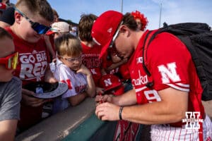 Nebraska Cornhusker infielder Rhett Stokes (9) signs an autograph after the win during a college baseball game on Saturday, May 9, 2026, in Lincoln, Neb. Photo by John S. Peterson.