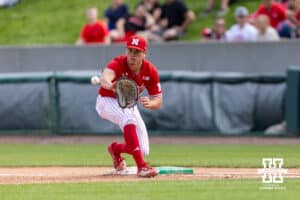 Nebraska Cornhusker infielder Case Sanderson (14) makes a catch for a force out at first against the Iowa Hawkeyes in the ninth inning during a college baseball game on Saturday, May 9, 2026, in Lincoln, Neb. Photo by John S. Peterson.