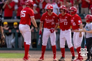 Nebraska Cornhusker Dylan Carey (15) celebrates his three run home run with Case Sanderson, Mac Moyer, and Trey Fikes in the eigthth inning against the Iowa Hawkeyes during a college baseball game on Saturday, May 9, 2026, in Lincoln, Neb. Photo by John S. Peterson.