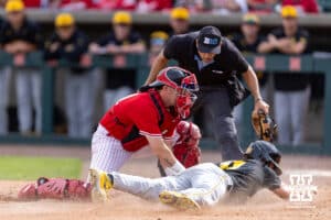 Nebraska Cornhusker catcher Trey Fikes (21) tags out Iowa Hawkeye Miles Risley (11) at home in the eighth inning during a college baseball game on Saturday, May 9, 2026, in Lincoln, Neb. Photo by John S. Peterson.