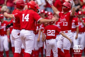 Nebraska Cornhusker Will Jesske (13) celebrates his grand slam with Case Sanderson, Dylan Carey, and Jeter Worthley in the third inning against the Iowa Hawkeyes during a college baseball game on Saturday, May 9, 2026, in Lincoln, Neb. Photo by John S. Peterson.