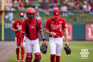 Nebraska Cornhusker starting pitcher Ty Horn (2) with catcher Jeter Worthley (0) walk down to the dugout for the start of the game against the Iowa Hawkeyes during a college baseball game on Saturday, May 9, 2026, in Lincoln, Neb. Photo by John S. Peterson.