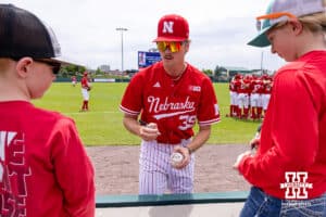 Nebraska Cornhusker pitcher Carson Jasa (39) signs an autograph for a young fan before taking on the Iowa Hawkeyes during a college baseball game on Saturday, May 9, 2026, in Lincoln, Neb. Photo by John S. Peterson.