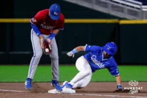 Creighton baserunner Lew Rice (3) slides into third base as Kansas third baseman Dylan Schlotterback (7) fumbles the ball in his glove during a college baseball game on Tuesday, May 5, 2026, in Omaha, Neb. Photo by Braden Cochran.