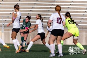 Lincoln Southwest Ansley Throener (9) scores kicks the ball past the Columbus defenders for her fourth goal for the game, adding one more for the record, in the second half during a high school soccer match on Wednesday, May 6, 2026, in Lincoln, Neb. Photo by John S. Peterson.