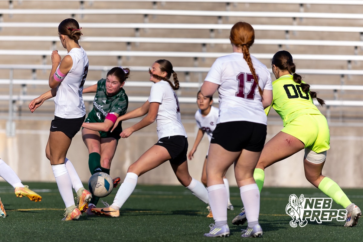 Lincoln Southwest v Columbus Girls Soccer | May 6, 2026 | NebPreps Lincoln Southwest Ansley Throener (9) scores kicks the ball past the Columbus defenders for her fourth goal for the game, adding one more for the record, in the second half during a high school soccer match on Wednesday, May 6, 2026, in Lincoln, Neb. Photo by John S. Peterson.