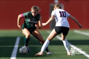 Lincoln Southwest Peyton Held (12) dribbles the ball against Columbus Kiera Schumacher (10) in the second half during a high school soccer match on Wednesday, May 6, 2026, in Lincoln, Neb. Photo by John S. Peterson.