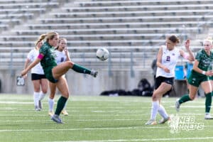 Lincoln Southwest Peyton Held (12) kicks the ball against Columbus Josie Larsen (2) in the first half during a high school soccer match on Wednesday, May 6, 2026, in Lincoln, Neb. Photo by John S. Peterson.