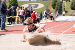 Leo Cauble lands in the sand during the Metro Conference T&F Meet on May 6, 2026, in Omaha, Nebraska. Photo by Brandon Tiedemann.