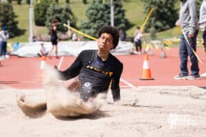 Pierce Parker lands in the sand during the Metro Conference T&F Meet on May 6, 2026, in Omaha, Nebraska. Photo by Brandon Tiedemann.