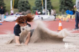 Dallas Davison lands in the sand during the Metro Conference T&F Meet on May 6, 2026, in Omaha, Nebraska. Photo by Brandon Tiedemann.