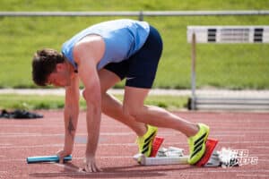 Ethan Laux gets into starting position during the Metro Conference T&F Meet on May 6, 2026, in Omaha, Nebraska. Photo by Brandon Tiedemann.