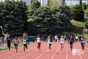 The girls 100m contestants sprint during the Metro Conference T&F Meet on May 6, 2026, in Omaha, Nebraska. Photo by Brandon Tiedemann.