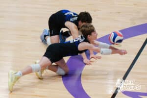 Lincoln South’s Owen Folken (2) and Alex Wagner (20) dive for a volleyball during a Nebraska boys volleyball state championship game against Burke on Sunday, May 3, 2026, in Bellevue, Neb. Photo by Jandi Green.