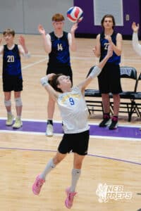 Lincoln South’s Nichalus Rojas (9) is serving a volleyball while Alex Wagner (20), Jackson Hollman (14) and Lincoln Boone (27) cheer in the back during a Nebraska boys volleyball state championship game against Burke on Sunday, May 3, 2026, in Bellevue, Neb. Photo by Jandi Green.