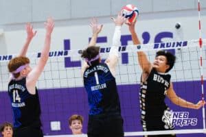 Lincoln South’s Jackson Hollman (14) and Nolan Beutler (1) blocking a volleyball from Burke's San Win (14) during a Nebraska boys volleyball state championship game against Burke on Sunday, May 3, 2026, in Bellevue, Neb. Photo by Jandi Green.