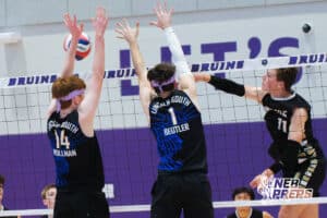 Lincoln South’s Jackson Hollman (14) and Nolan Beutler (1) blocking a volleyball from Burke's Josh Morgan (11) during a Nebraska boys volleyball state championship game against Burke on Sunday, May 3, 2026, in Bellevue, Neb. Photo by Jandi Green.