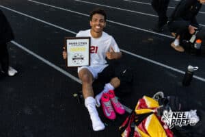 Roncalli’s Jordan Martinez (21) is posing with the championship plaque after winning the River Cities Conference Championship against South Sioux City on Thursday, April 30, 2026 in South Sioux City, Nebraska. Photo by Jack Stephens.