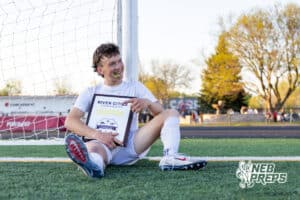 Roncalli’s Eli Mace (7) is posing with the championship plaque after winning the River Cities Conference Championship against South Sioux City on Thursday, April 30, 2026 in South Sioux City, Nebraska. Photo by Jack Stephens.