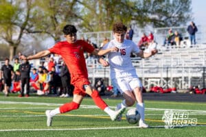 Roncalli’s Will Preston (16) is dribbling the ball through contact during a high school soccer game against South Sioux City on Thursday, April 30, 2026 in South Sioux City, Nebraska. Photo by Jack Stephens.
