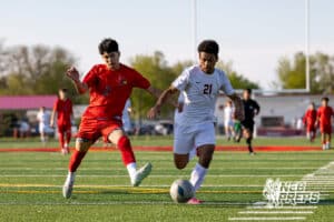 Roncalli’s Jordan Martinez (21) is dribbling the ball past a defender during a high school soccer game against South Sioux City on Thursday, April 30, 2026 in South Sioux City, Nebraska. Photo by Jack Stephens.