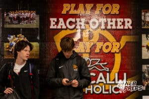 Roncalli’s Tony DeSalvo (10) and Lucio Garcia (11) are standing in front of a wall in their locker room that reads: “Play for each other, Play for Roncalli Catholic” before the bus ride to South Sioux City on Thursday, April 30, 2026 in Omaha, Nebraska. Photo by Jack Stephens.