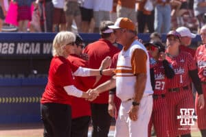 Nebraska Cornhusker head coach Rhonda Revelle shakes hands with Texas Longhorn head coach Mike White after the game during the WCWS elimination game on Sunday, May 31, 2026, in Oklahoma City. Photo by John S. Peterson.