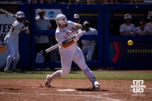 Texas Longhorn utility Katie Stewart (20) hits a three-run home run in the sixth inning against the Nebraska Cornhuskers during the WCWS elimination game on Sunday, May 31, 2026, in Oklahoma City. Photo by John S. Peterson.