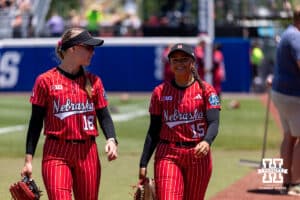 Nebraska CornhuskeNessa McMillen (18) and Kennadi Williams walk to the dugout s during the WCWS elimination game on Sunday, May 31, 2026, in Oklahoma City. Photo by John S. Peterson.