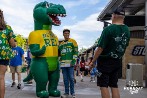 Runza Rex posing with fans during a Storm Chasers game on Saturday, May 30, 2026, in Omaha, Neb. Photo by Jandi Green.