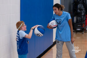 Creighton Bluejay Kiani Lockett talks to a camper during their yearly abilities camp on June 5, 2026, in Omaha, Nebraska. Photo by Brandon Tiedemann.